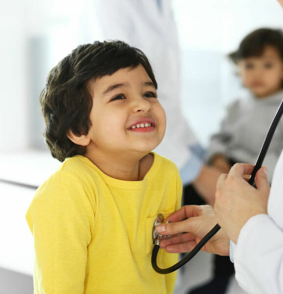 a doctor using a stethoscope on a child