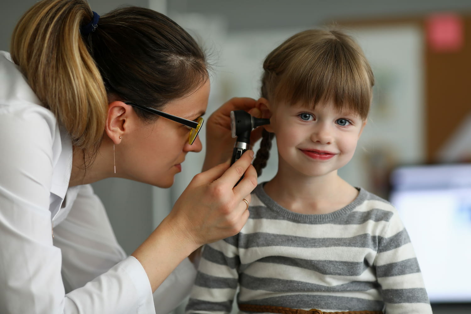 a paediatric ENT assessing a child's ear