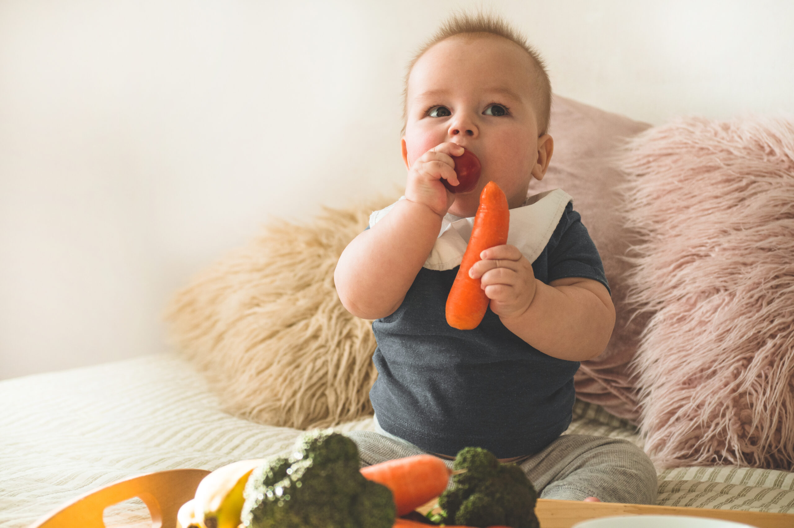 First solid food for young kid. Fresh organic carrot for vegetable lunch. Baby weaning. First solid food for young kid. Fresh organic carrot for vegetable lunch. Baby weaning.