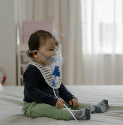 A baby with a oxygen mask