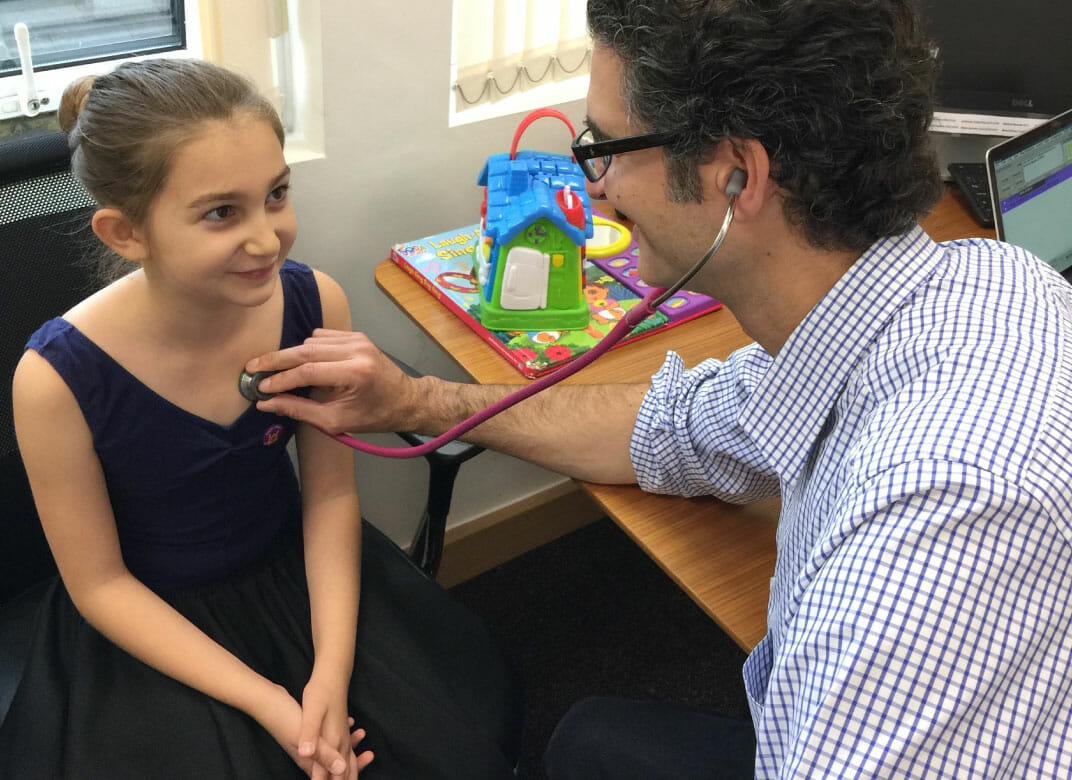 Dr Yiannis examining a little girl